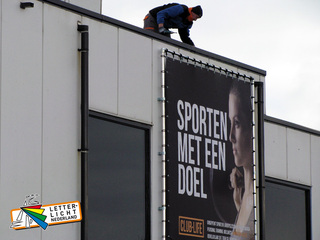 Reclame spandoek in  wandframe monteren